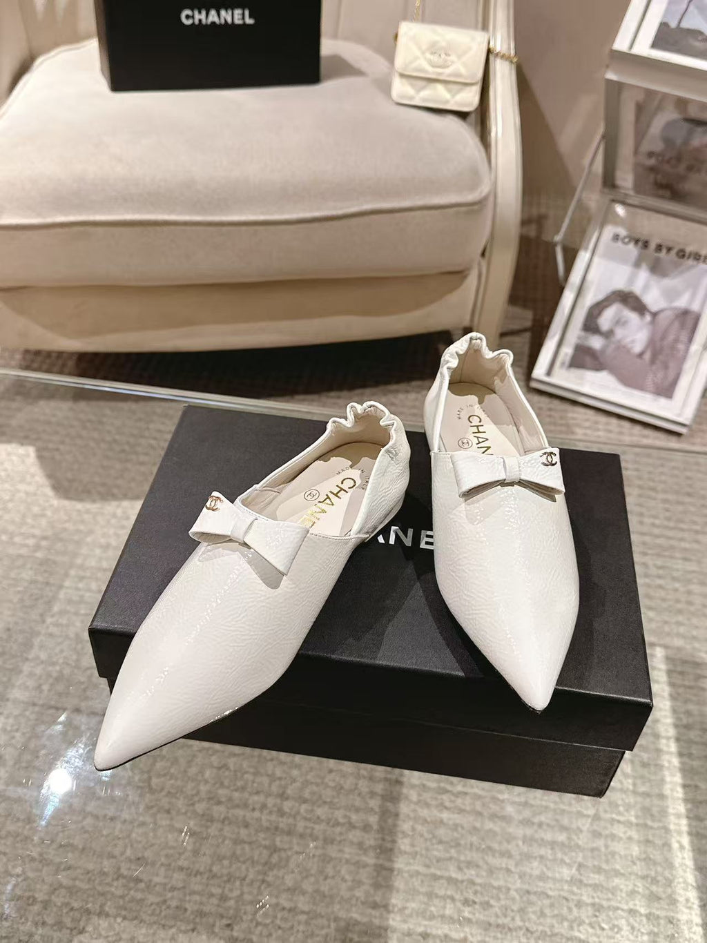 White leather pointed-toe flats with bow strap detail