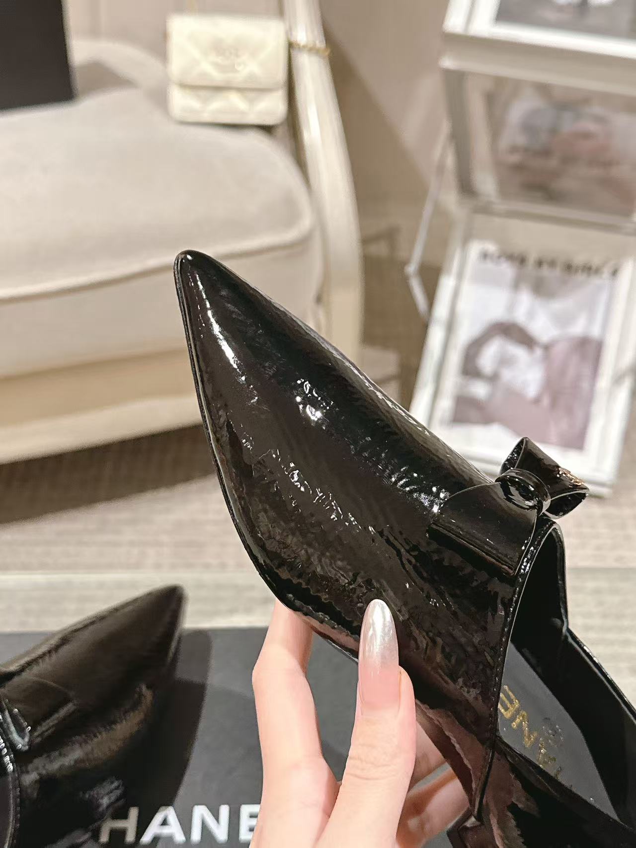 Black patent leather ladies pointed-toe slip-on shoes with bow and low block heel