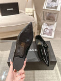 Black patent leather ladies slip-on shoes, pointed toe, low block heel, bow strap
