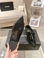 Black patent leather ladies slip-on shoes, pointed toe, low block heel, bow strap