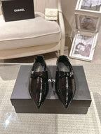 Black patent leather ladies pointed-toe slip-on shoes with bow straps and low heel