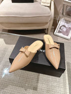 Beige patent mule slides with bow strap and pointed toe pair