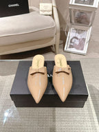 Beige patent mule slides with bow strap and pointed toe, front view