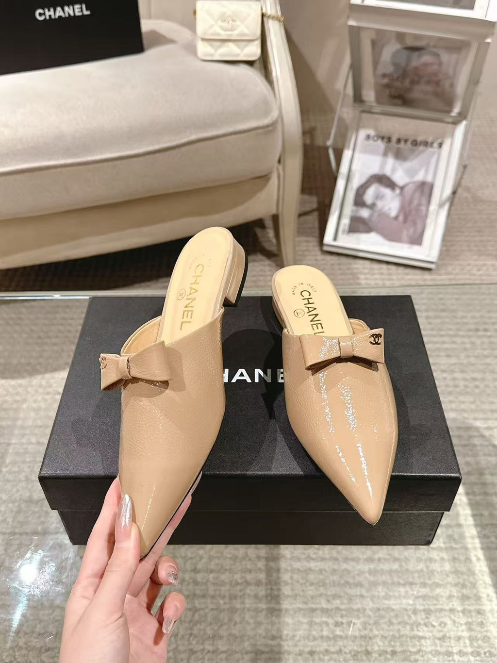 Beige patent mule slides with bow strap, pair on display box