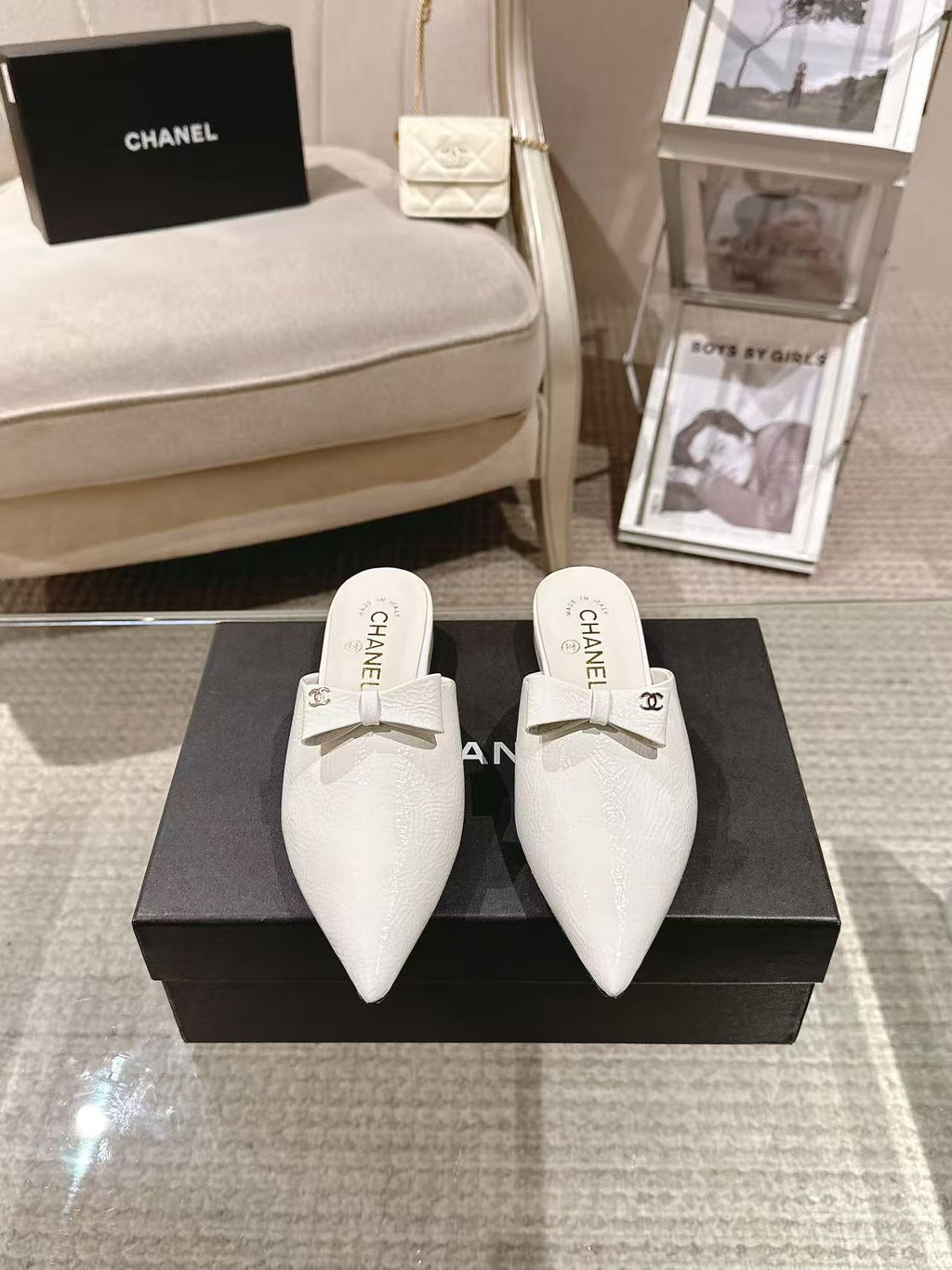 White Chanel pointed-toe flats with bow strap, front view pair