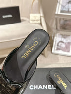 Women’s black patent mule insole view with MADE IN and CHANEL lettering