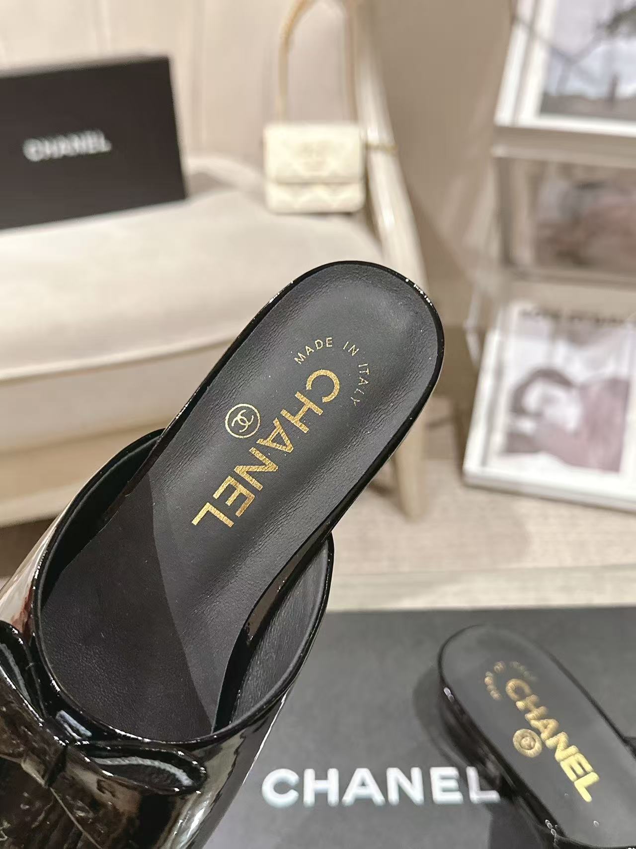 Women’s black patent mule insole view with MADE IN and CHANEL lettering