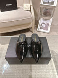 Women’s patent leather pointed-toe mules, glossy black with CHANEL heel branding