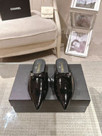 Women’s patent leather pointed-toe mules, glossy black with CHANEL heel branding