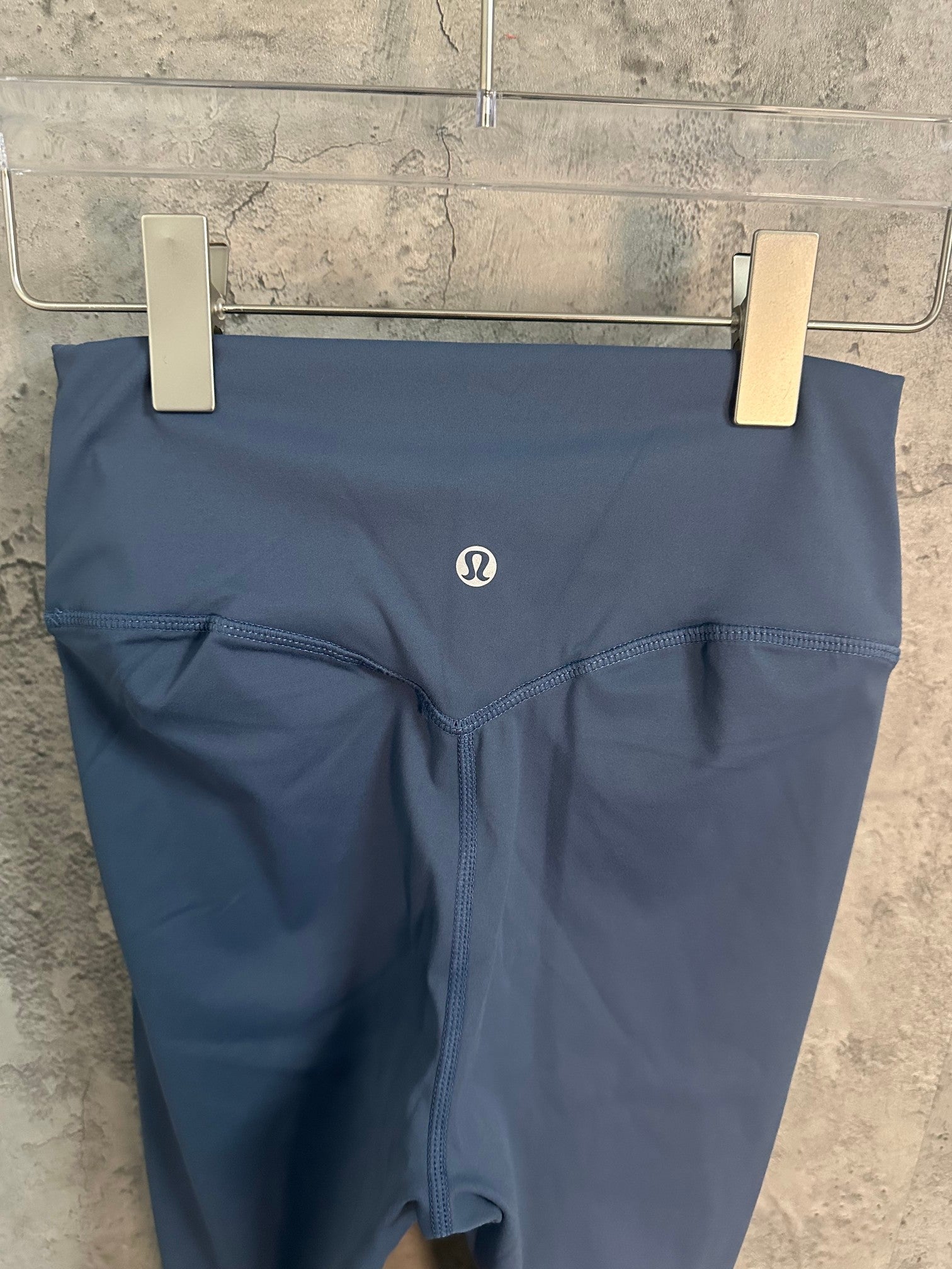 Blue leggings with small logo near waistband and gusset