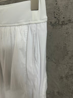 White skirt front with elastic waistband and pleated drape
