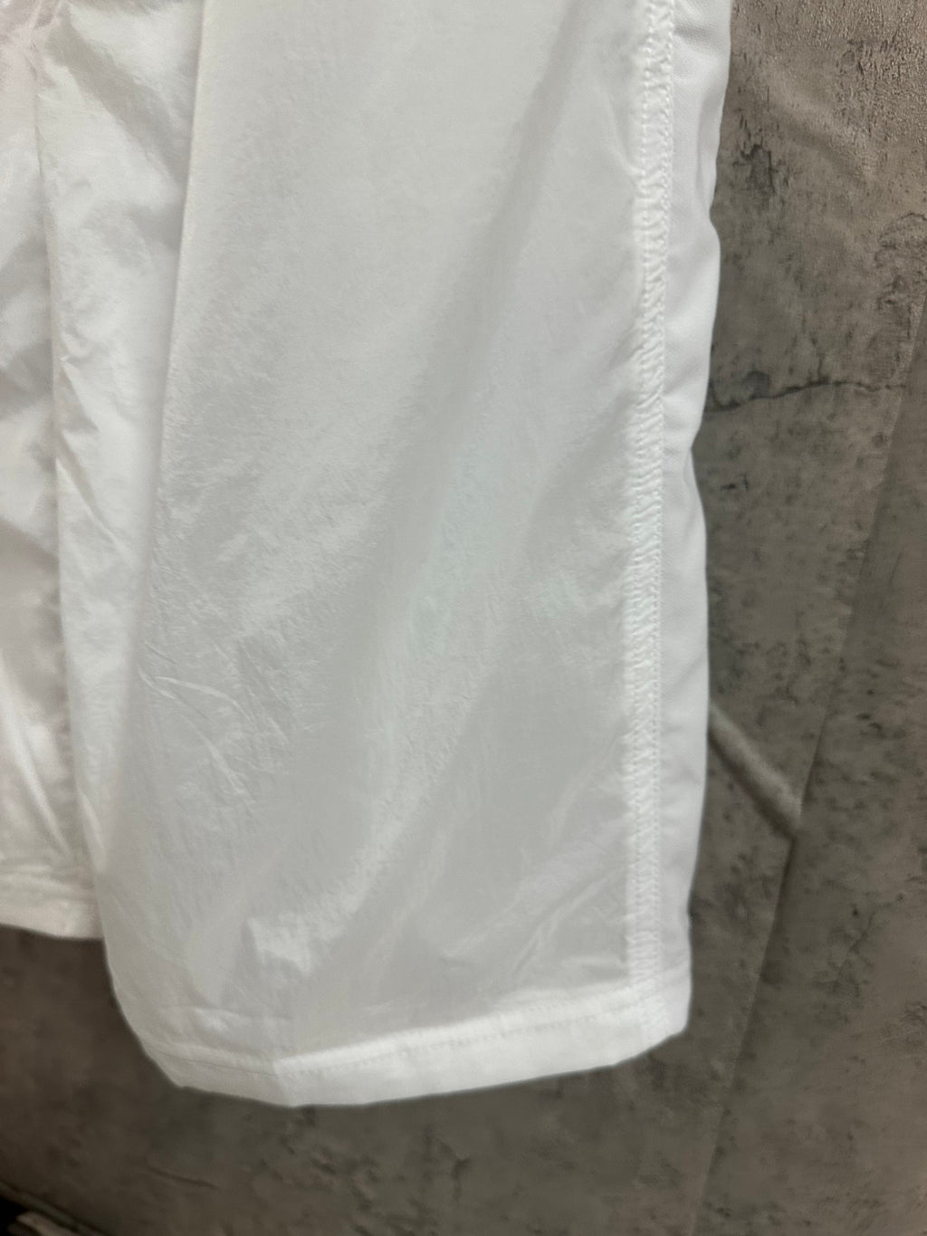 White skirt fabric panel with vertical seam and smooth drape