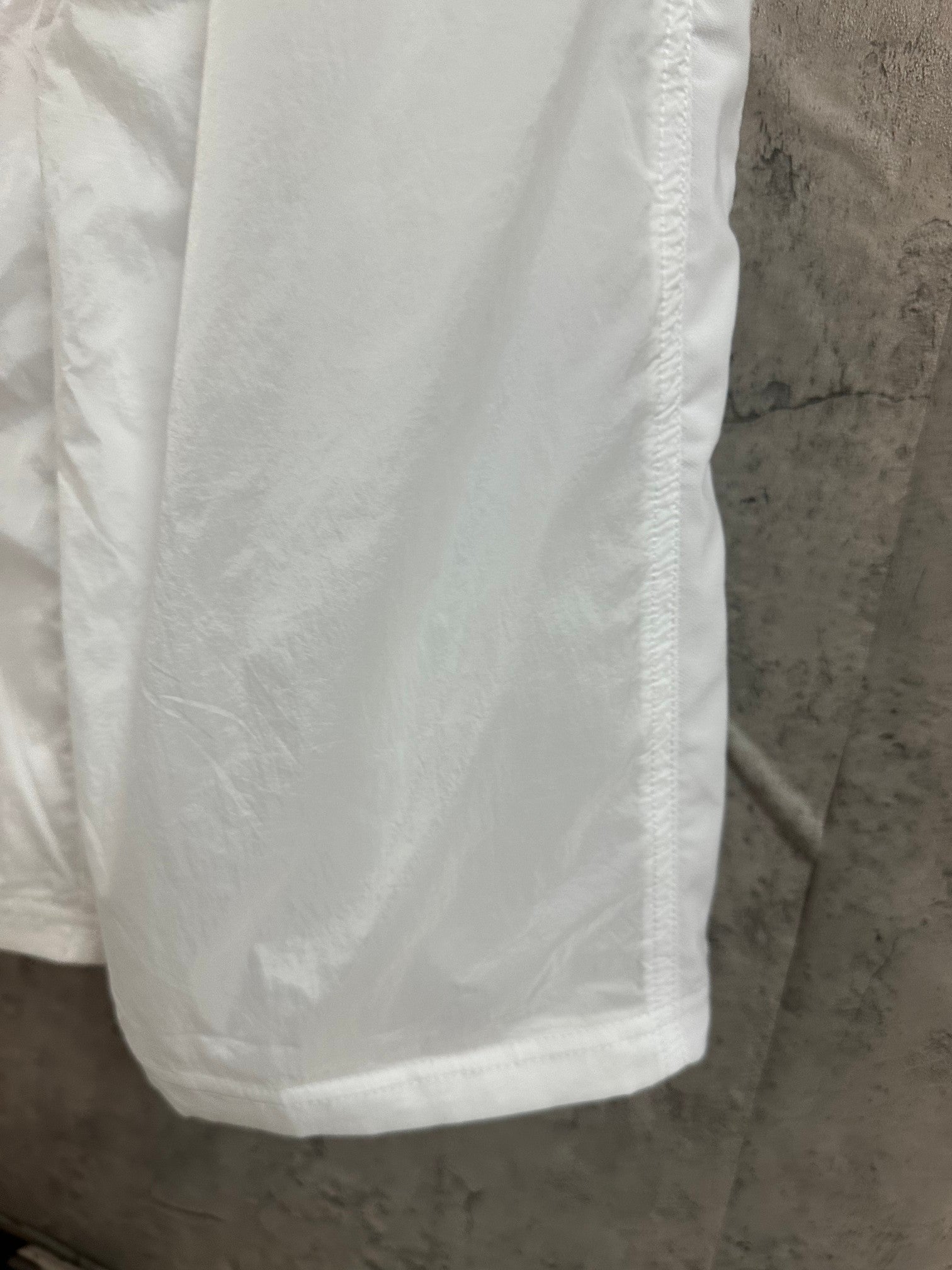 White skirt fabric panel with vertical seam and smooth drape