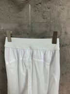 White skirt on hanger with elastic waistband and pleated front