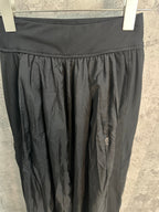 Dark pants waistband with elastic rib and gathered pleated panel