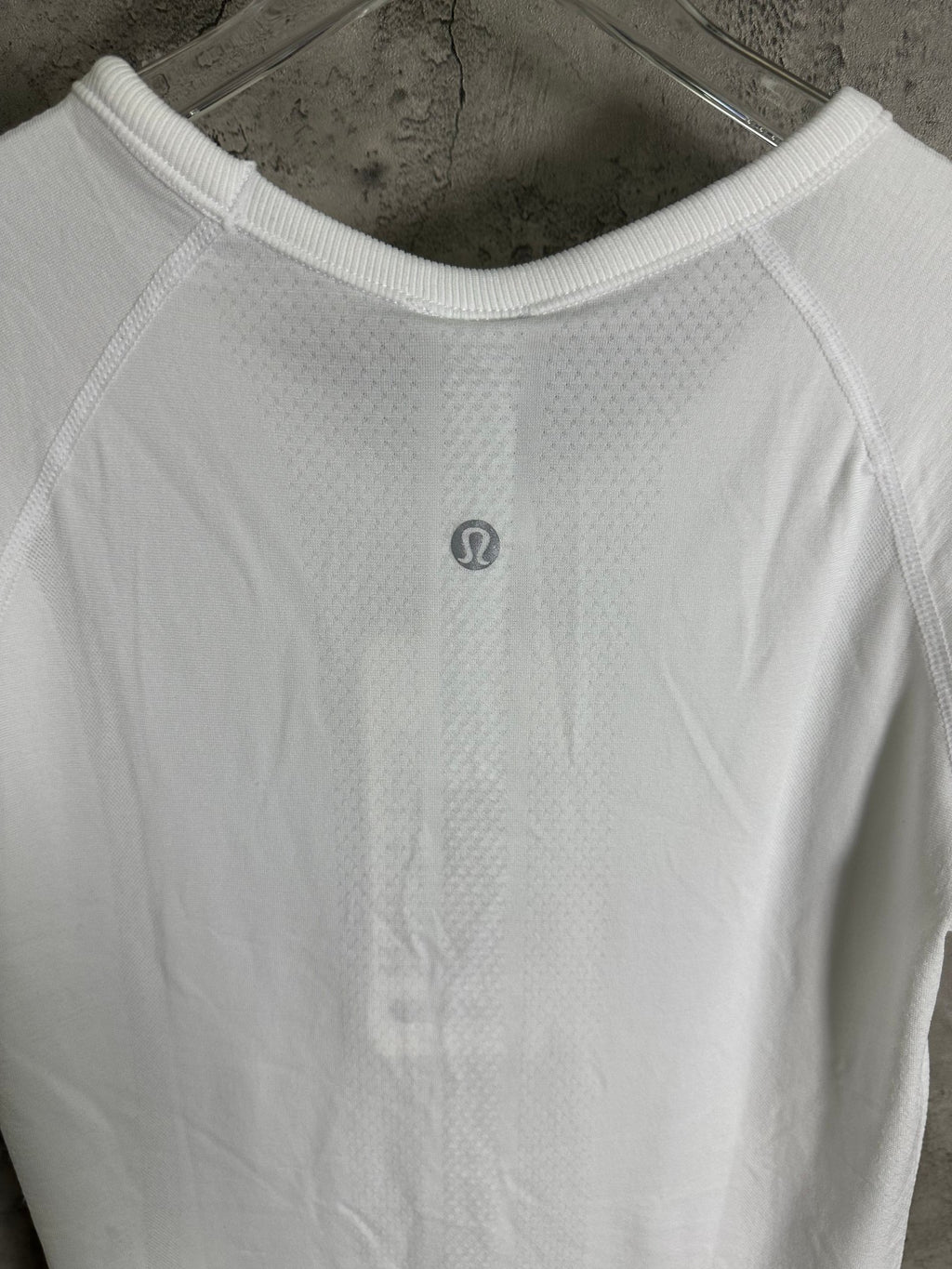White crew-neck T-shirt with tonal logo at center chest