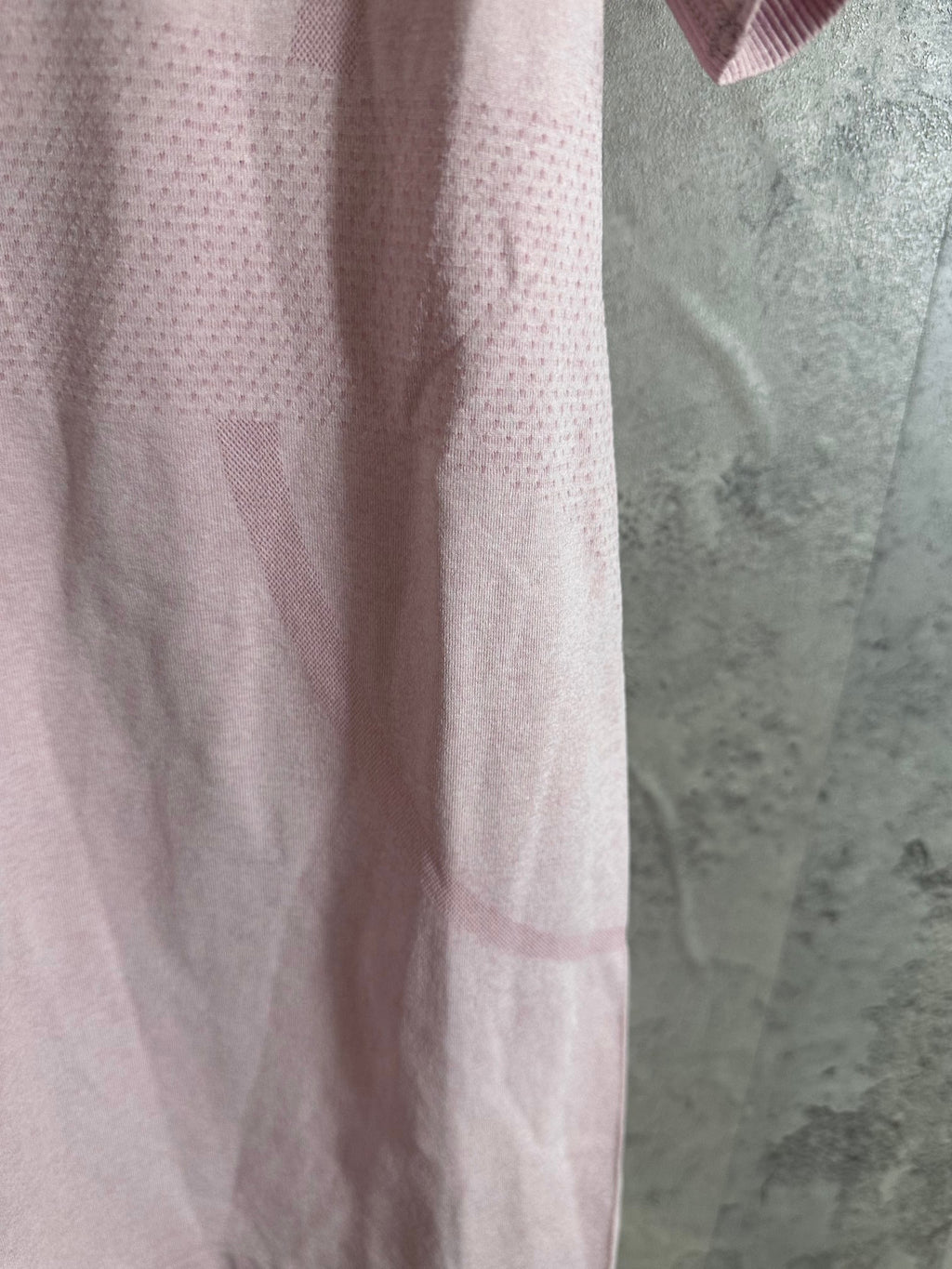 Pink short-sleeve T-shirt side view, stitched hem and texture