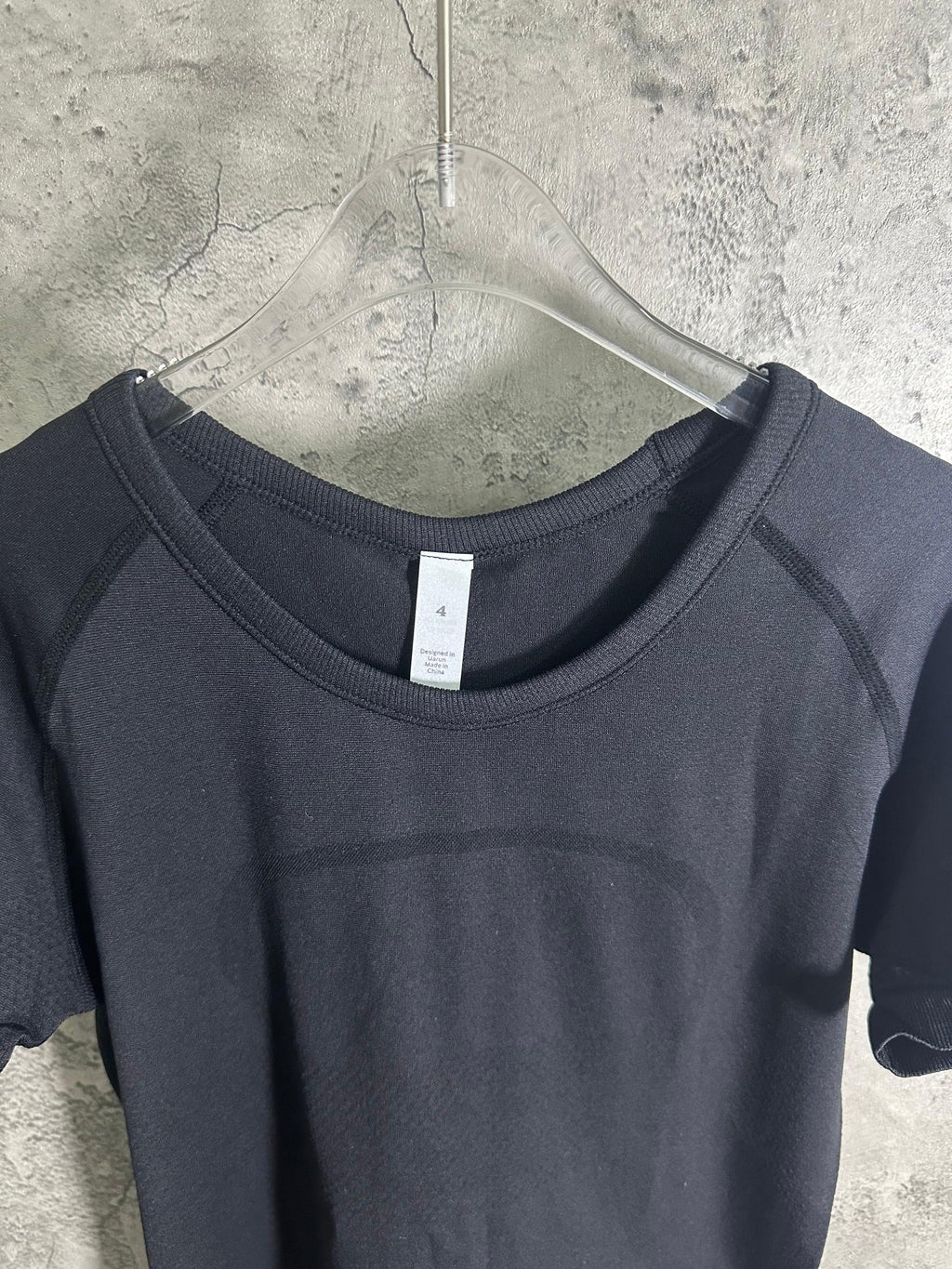 Dark heather crew-neck T-shirt neckline with white size tag at center back