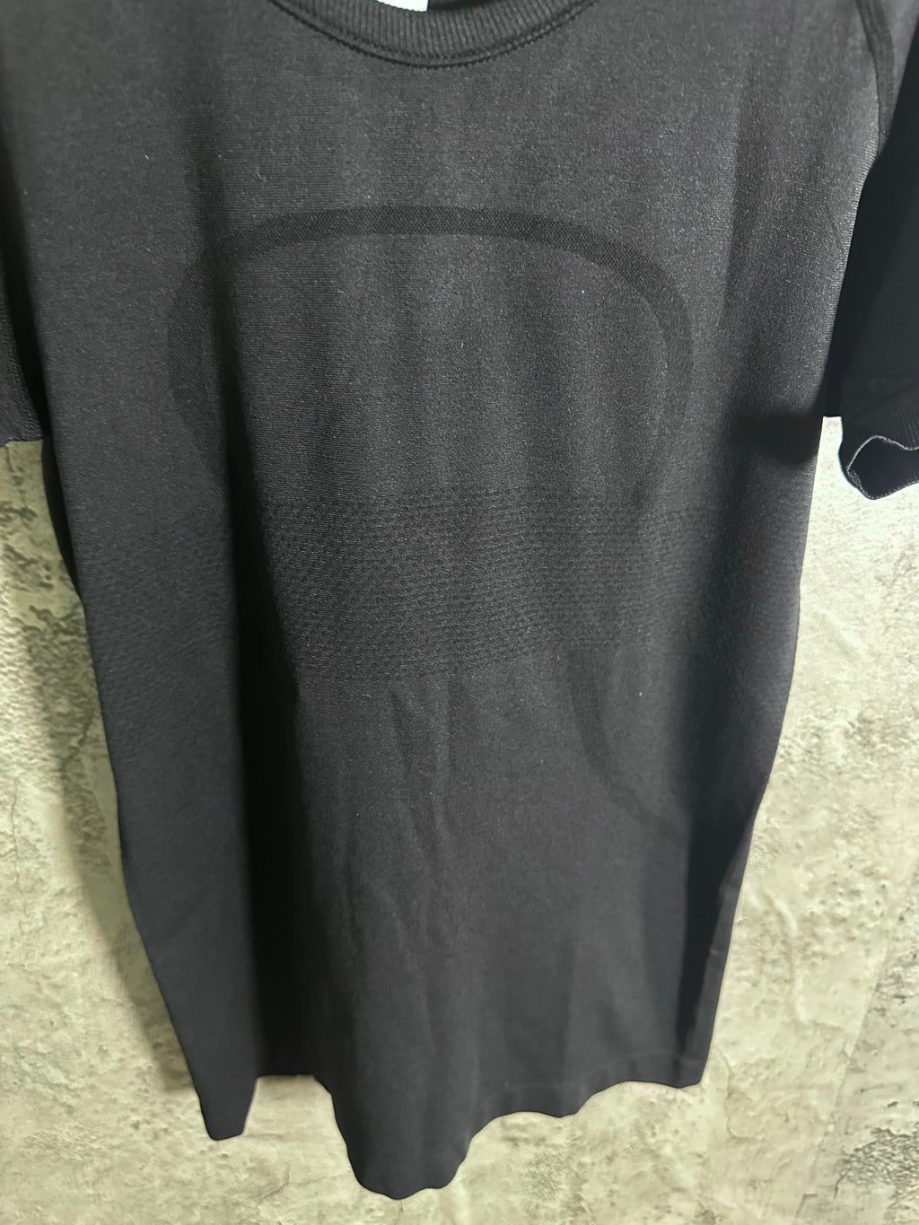 Dark heather crew-neck T-shirt hem view, short sleeves