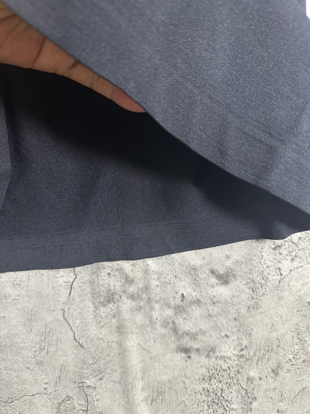 Dark heather T-shirt fabric close-up showing smooth knit texture