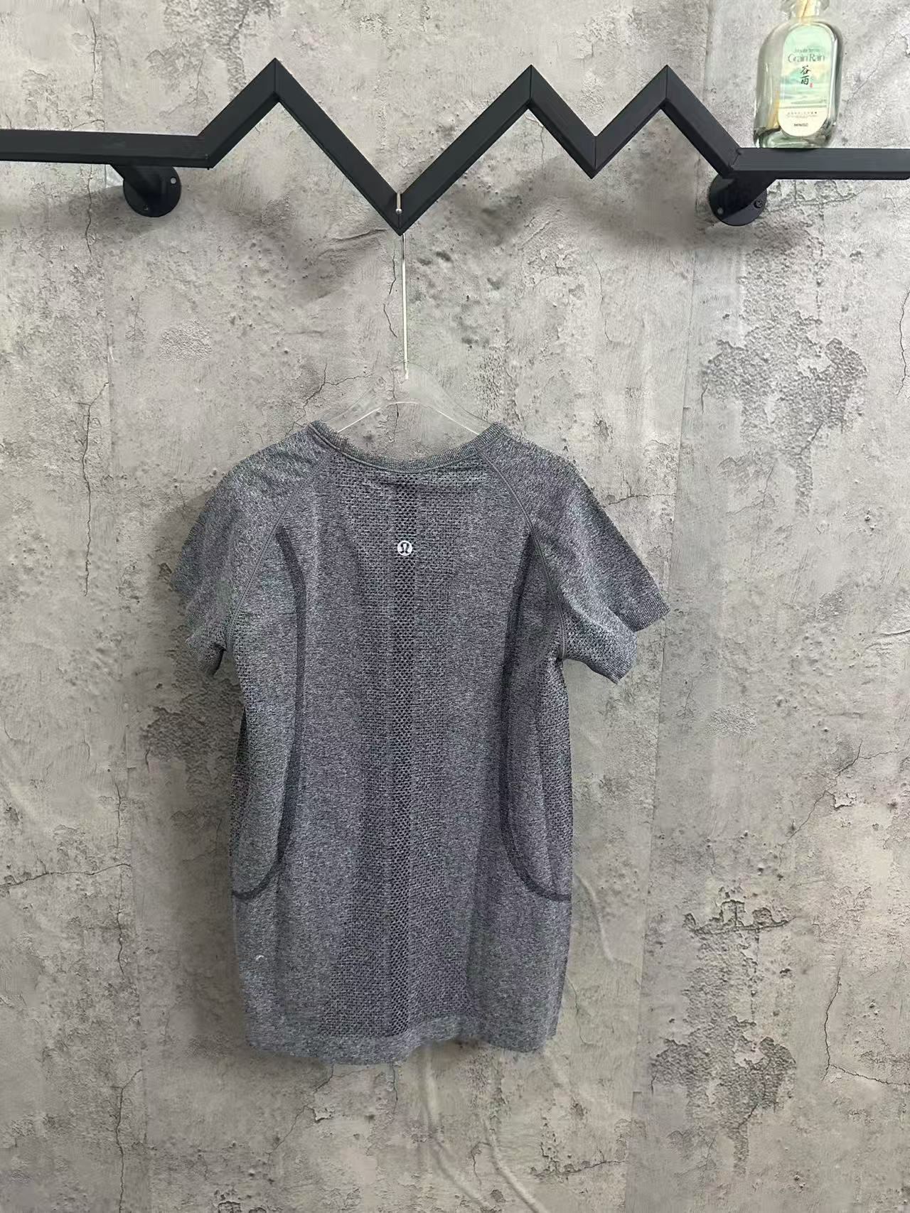 Kids gray heather T-shirt back view with vertical textured panel and small button
