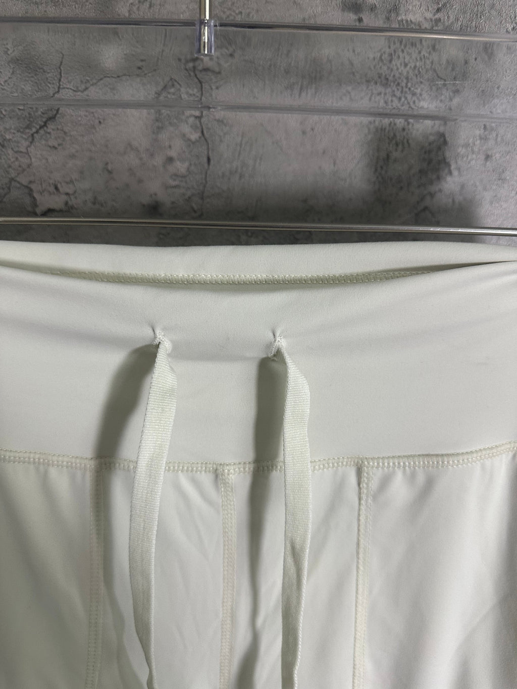White pants waistband with stitched seam and inner drawstring ties