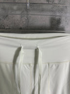 White pants waistband with stitched seam and inner drawstring ties