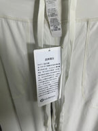 White trouser care labels hanging from waistband