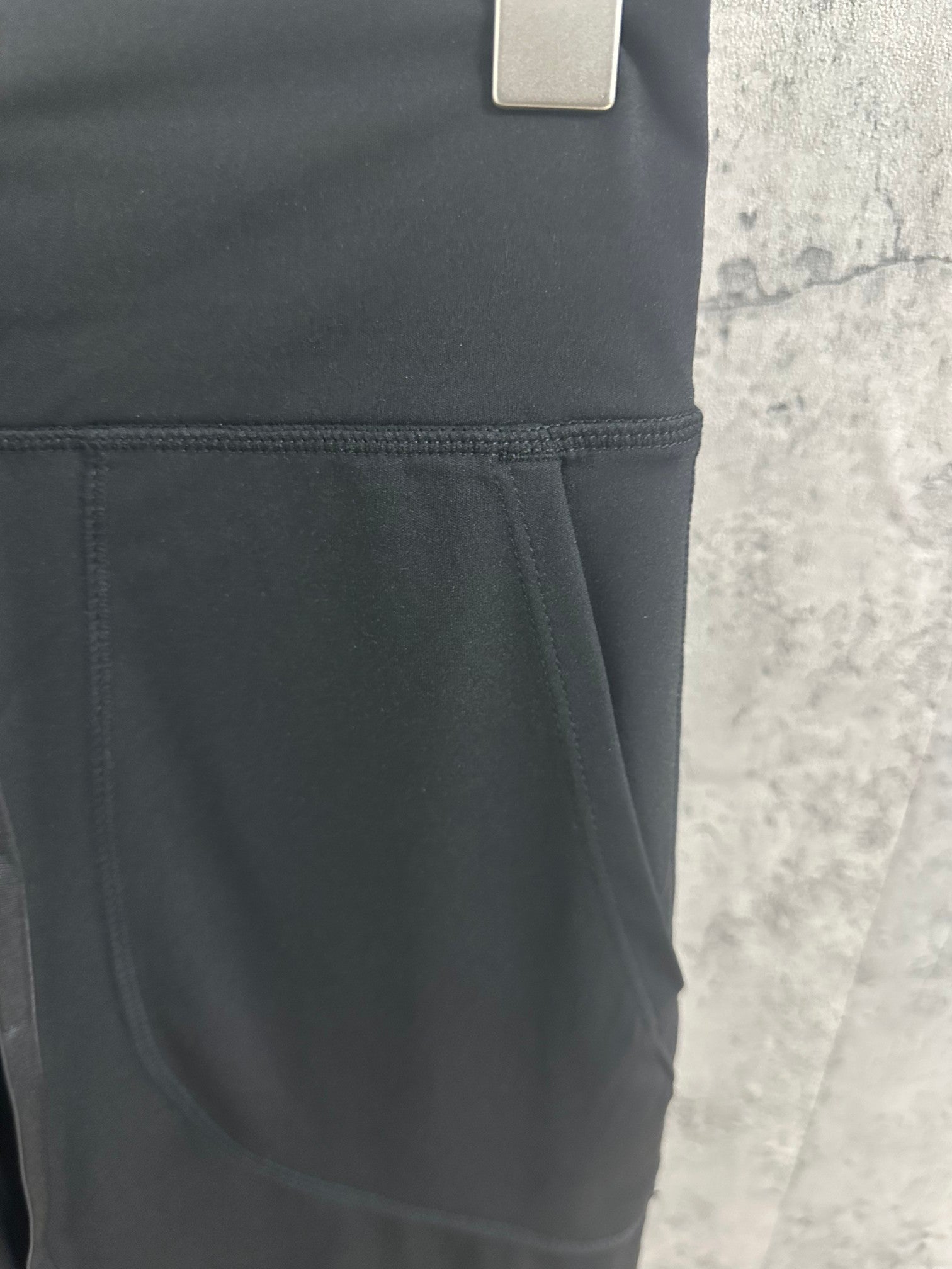 Black pants pocket with stitched seam detail