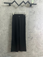 Black wide-leg pants with buttoned waistband and belt loops