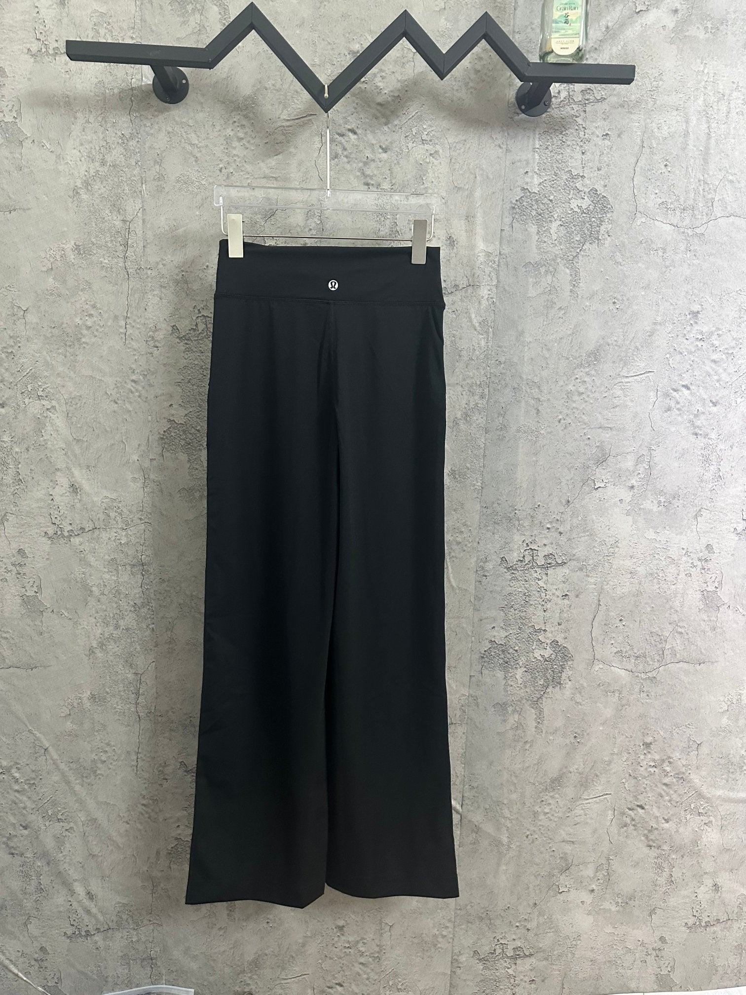 Black wide-leg pants with buttoned waistband and belt loops