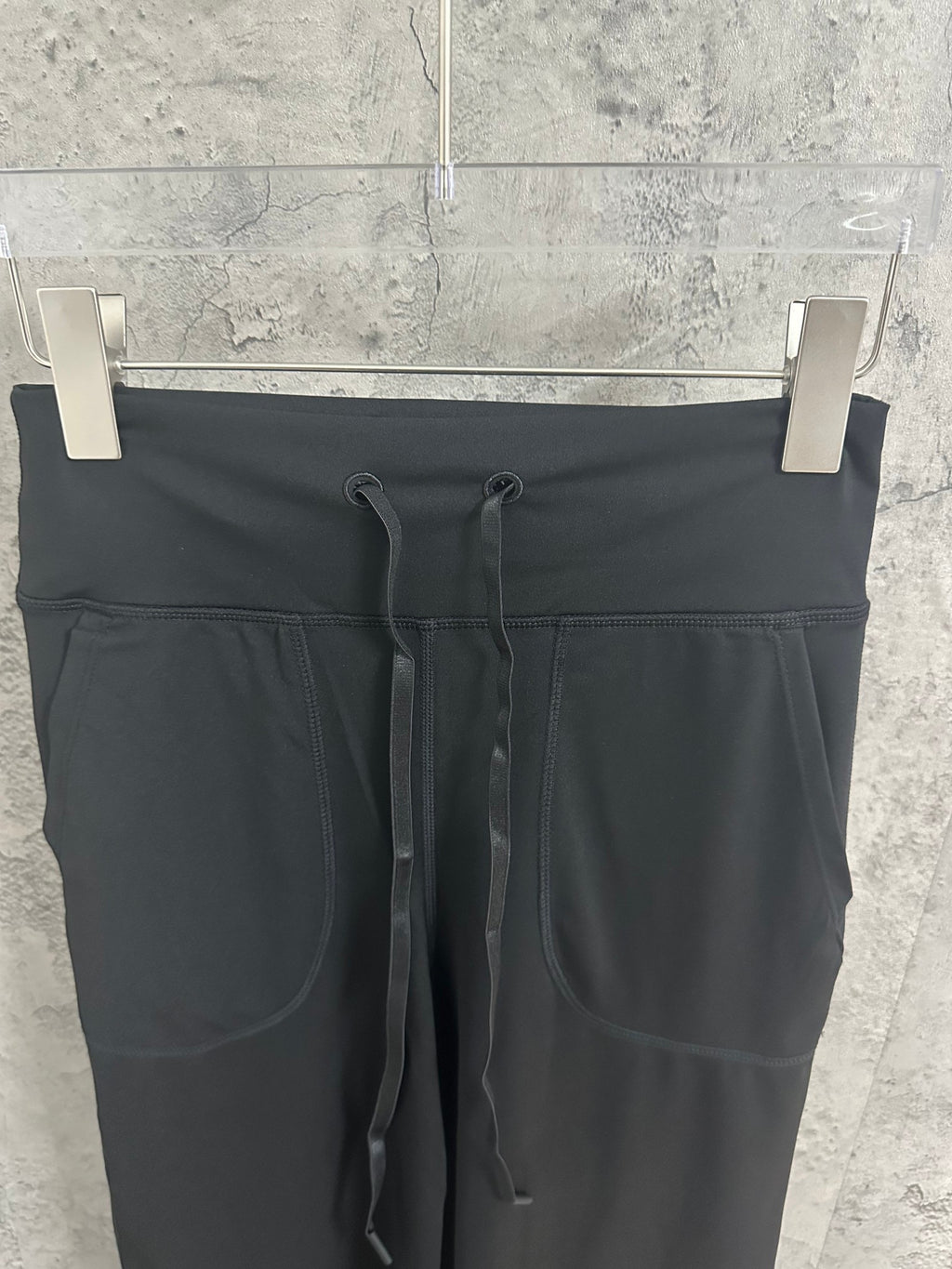 Black drawstring pants with faux pockets and elastic waistband