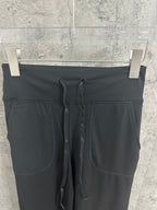 Black drawstring pants with faux pockets and elastic waistband
