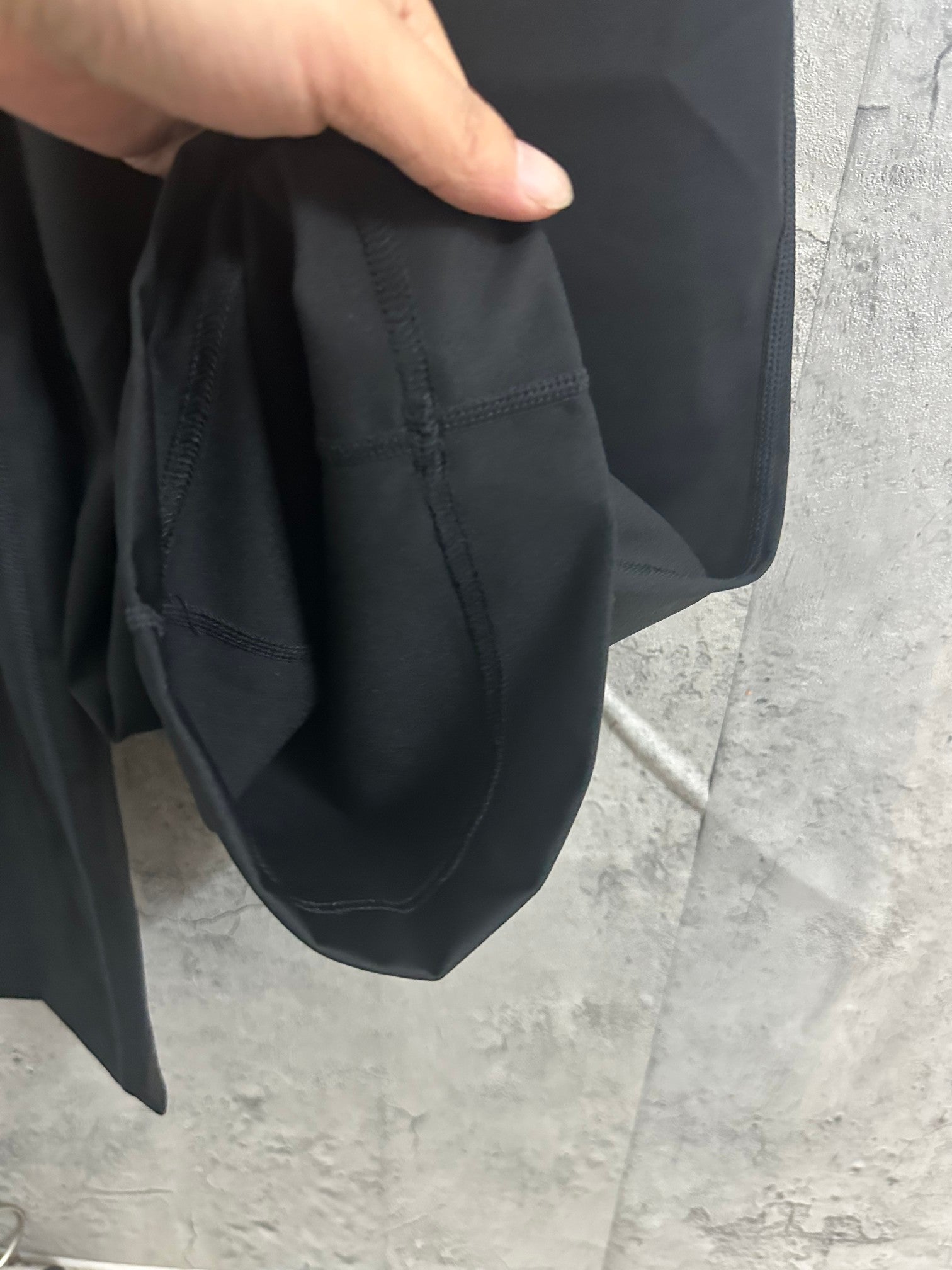 Dark pants pocket opening with drawstring at the waist