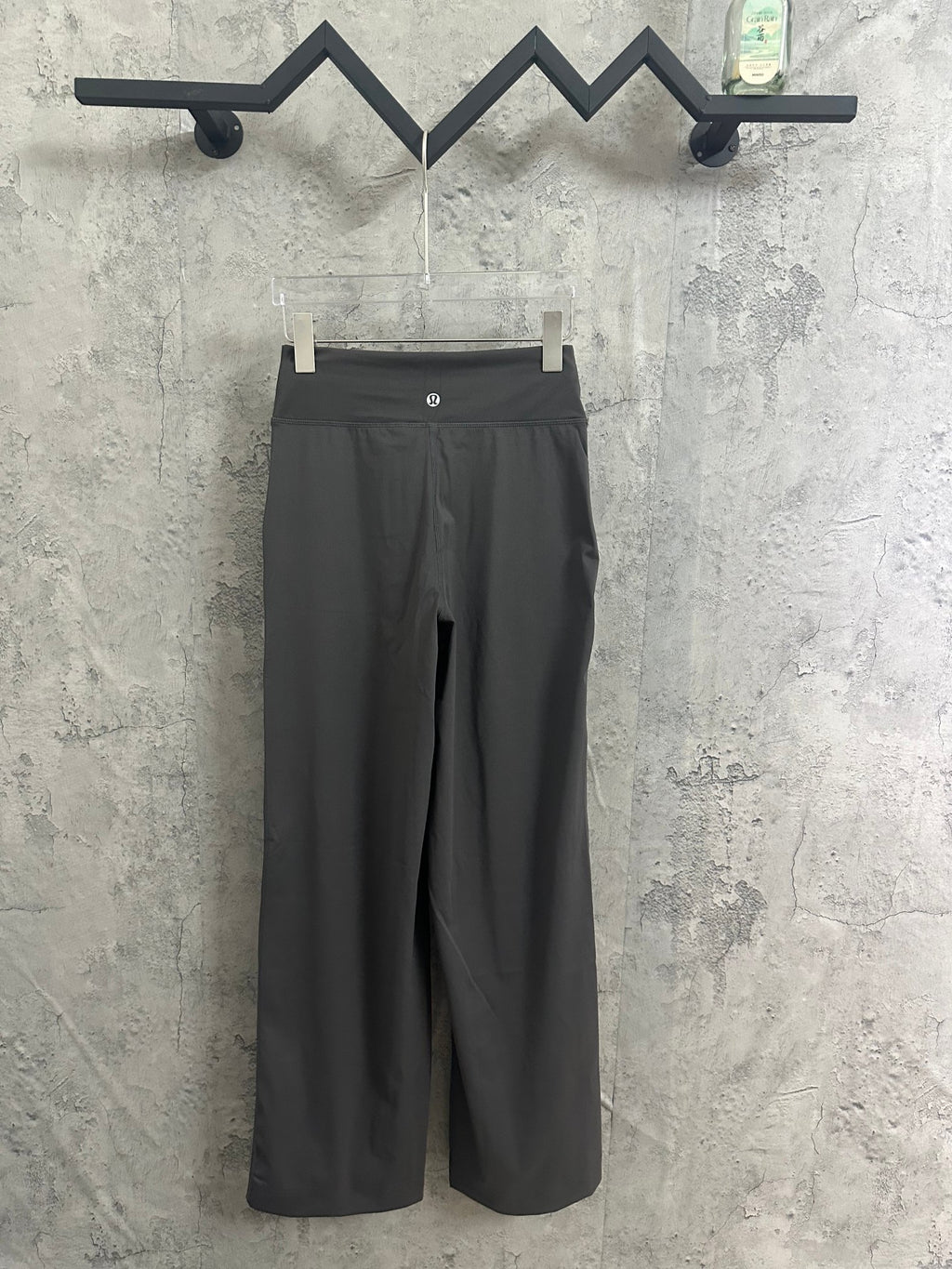 Dark gray wide-leg drawstring pants with logo on waistband