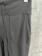 Dark gray pants with stitched front panels and side pocket seams