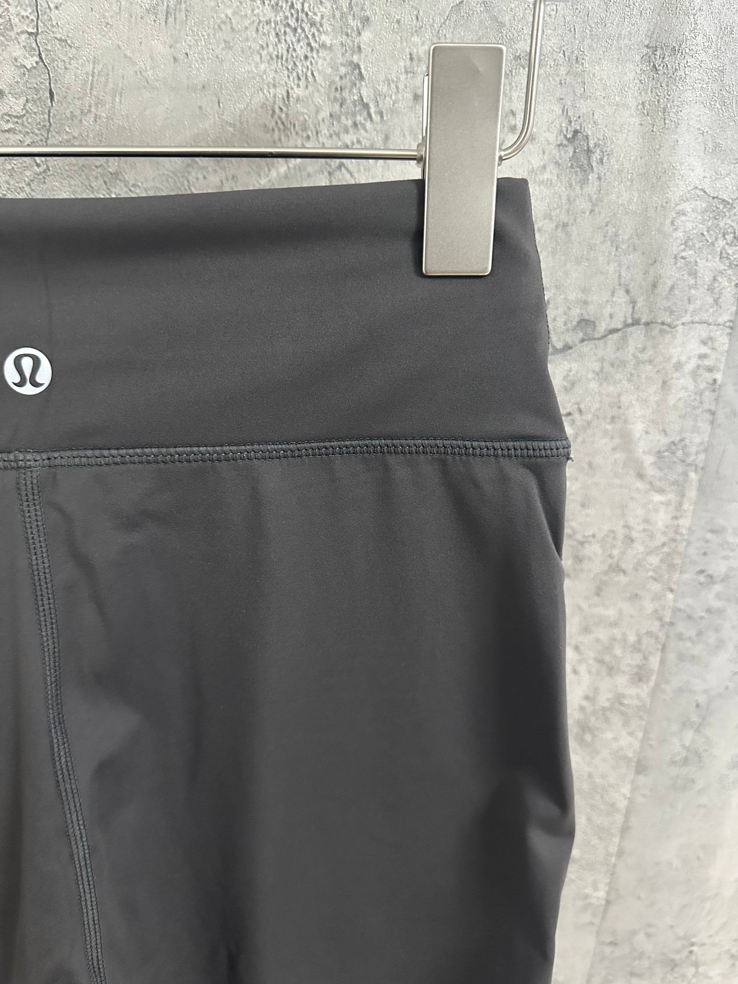 Dark gray pants with waistband pocket and side seam stitching