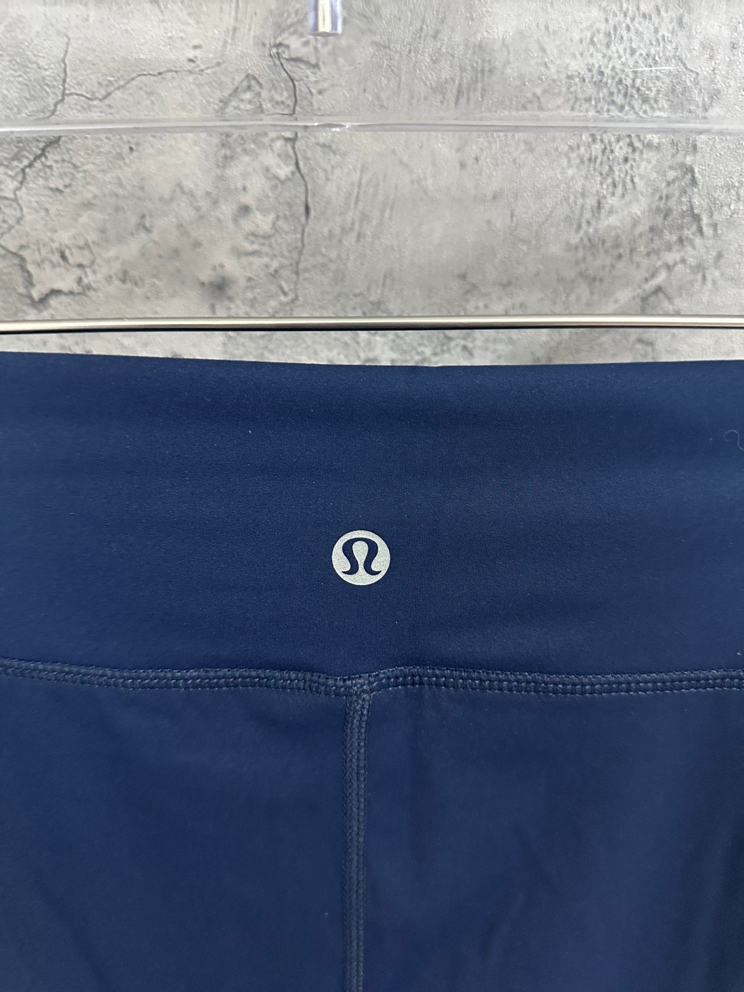 Navy waistband logo patch and stitched drawstring detail