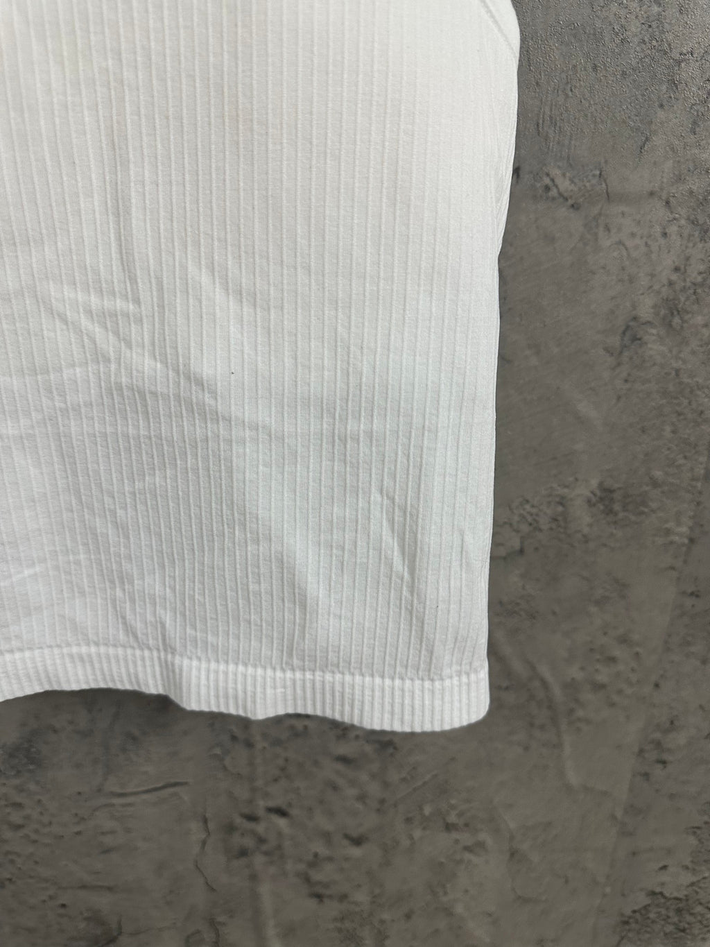 White ribbed knit tank top hem and side seam