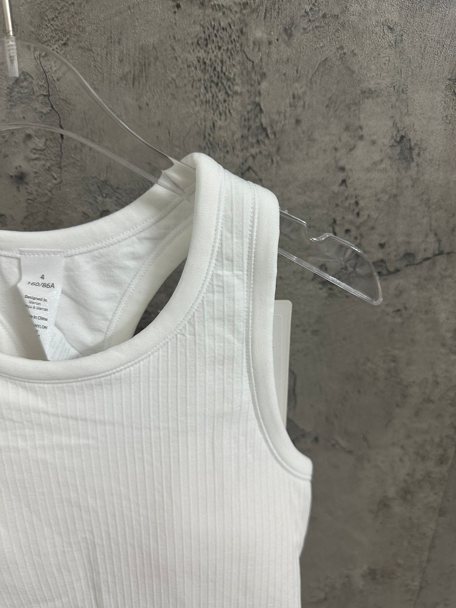 White ribbed knit tank top close-up neckline