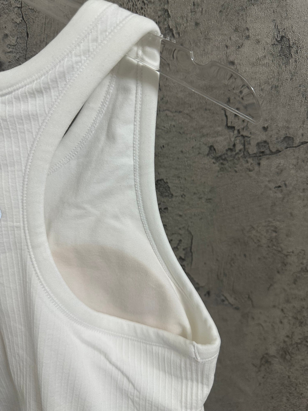 White ribbed knit tank top armhole and stitching