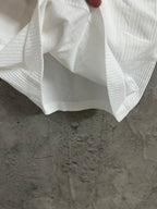 White ribbed tank top with flared hem and draped fabric
