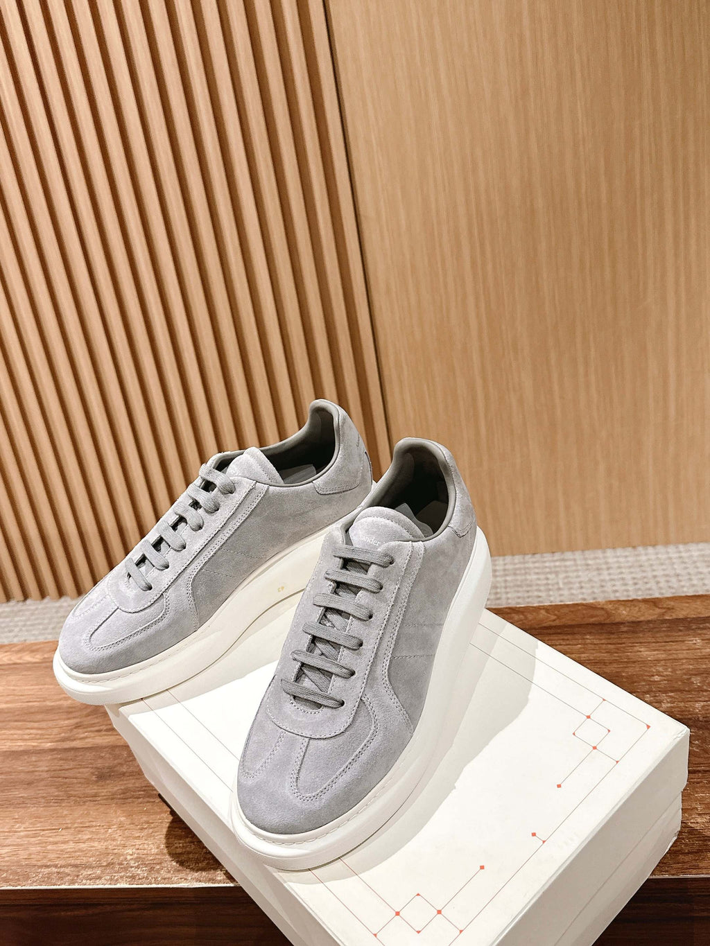 Alexander McQueen suede sneakers, light gray with lace-up detailing and thick white sole