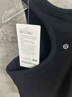 Ribbed tank top with care label and barcode tag hanging from side