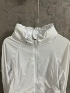 White hooded zip jacket close-up of hood and front zipper