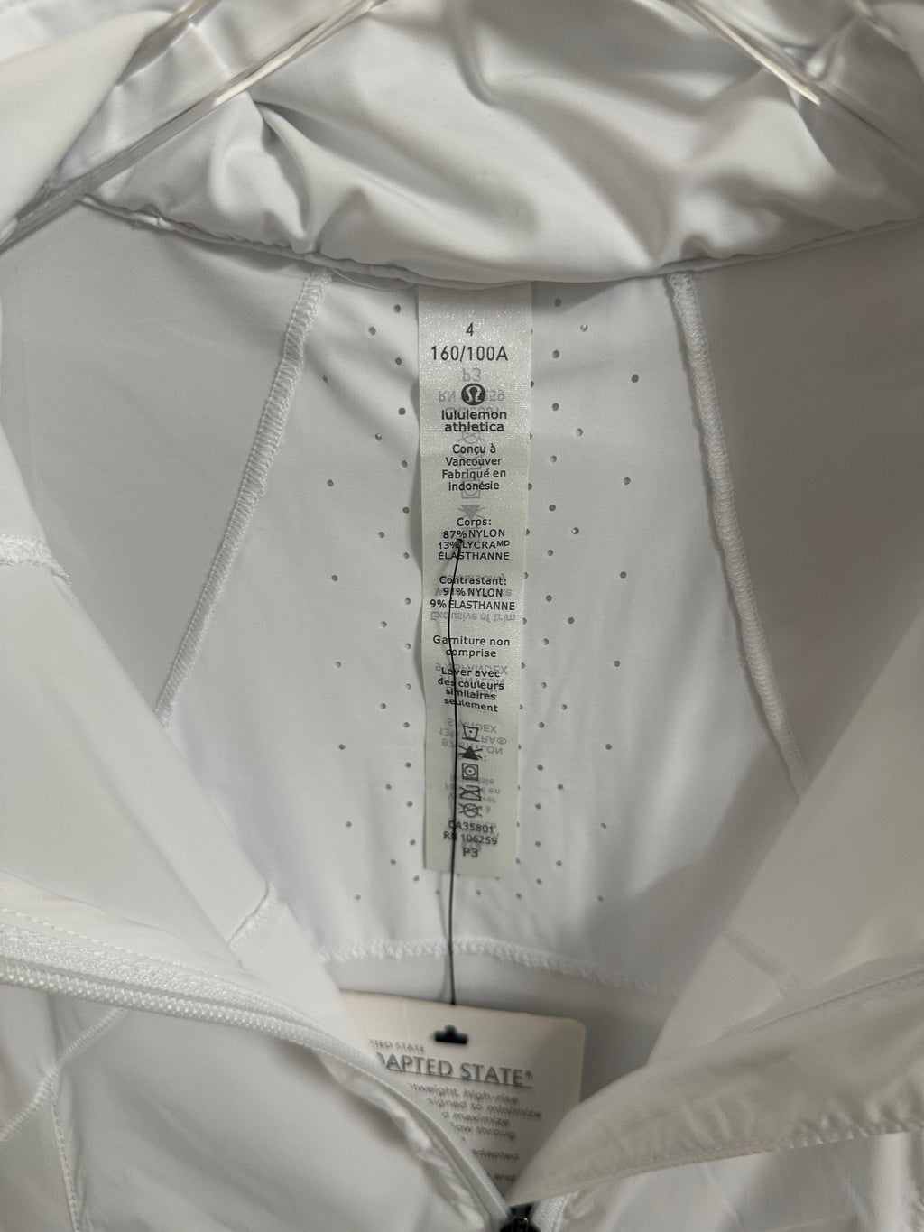 White jacket interior care label and size tag