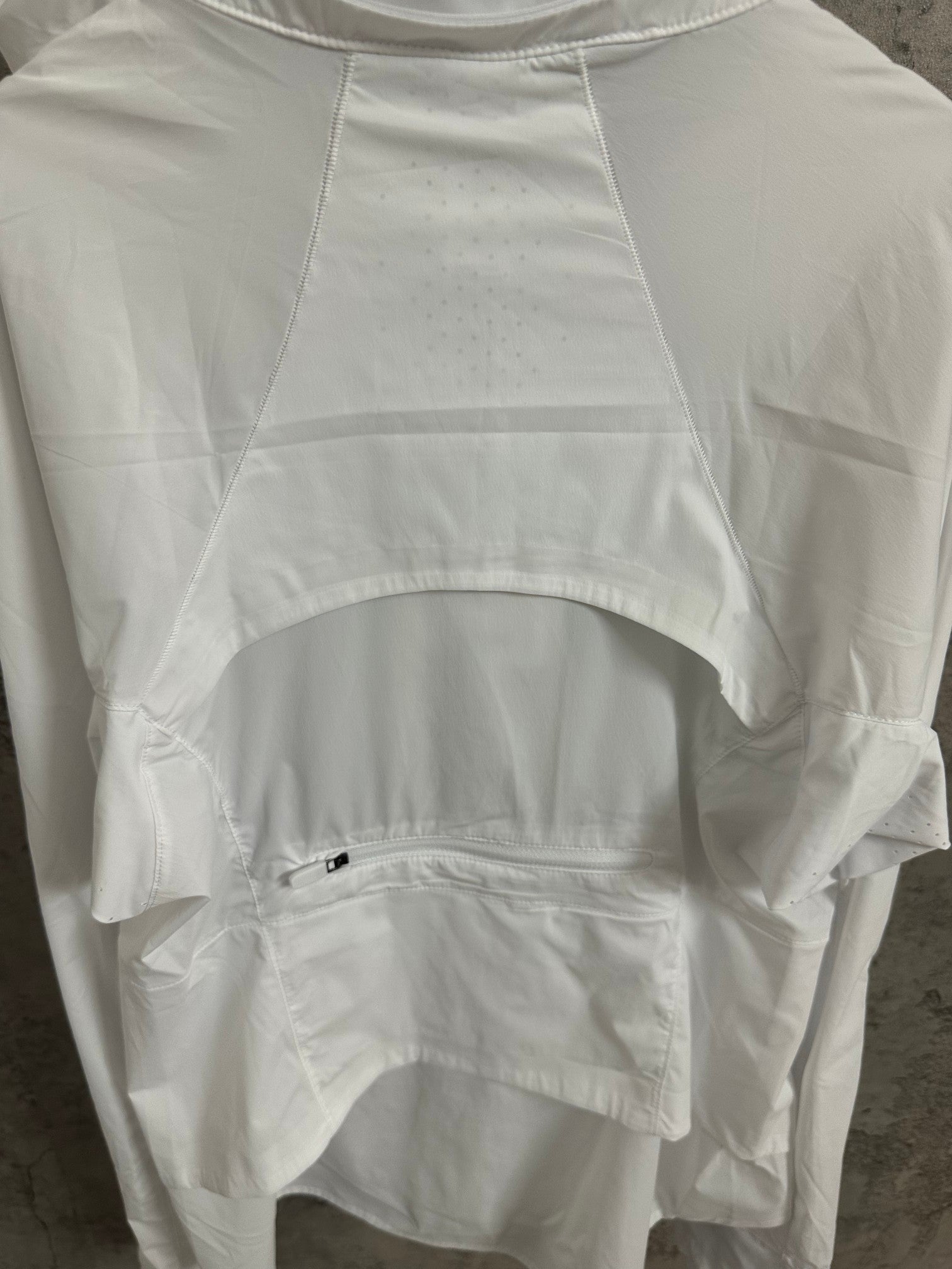 White jacket upper front with curved hem and small chest pocket