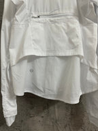 White jacket front with zipped pocket and small embroidered logo on hem