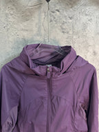 Purple hooded windbreaker jacket with center zipper and collar