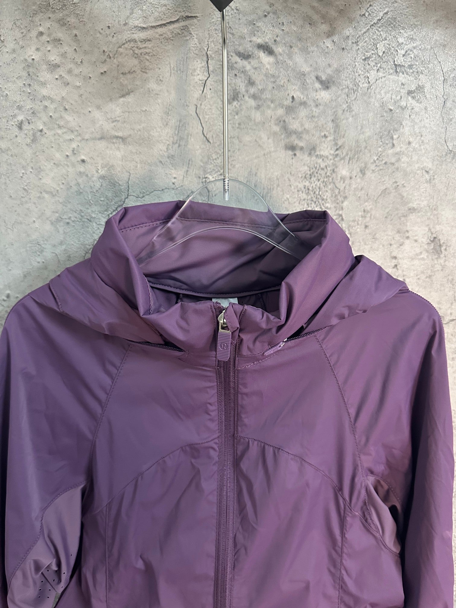 Purple hooded windbreaker jacket with center zipper and collar